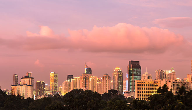 Purple sunset over the modern buildings along Jalan Thamrin in Jakarta, the capital city of Indonesia