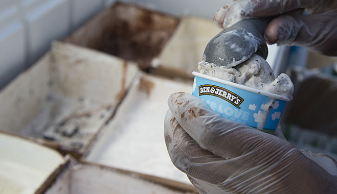 An employee serving Ben and Jerry’s ice cream. The company is known for donating a portion of its profits to charity, and for paying above the living wage