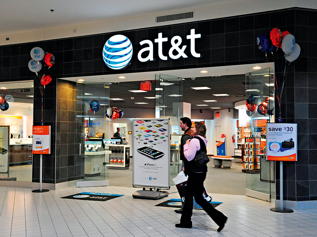 Shoppers pass an AT&T phone store. The telco giant could be drawn to the Mexican market