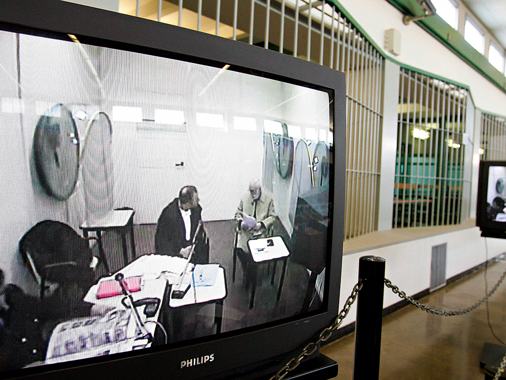 Giuseppe Calo (right on screen) appears by video link from a prison in central Italy during the trial of the alleged murderer of Roberto Calvi, 23 years after his body was found in London