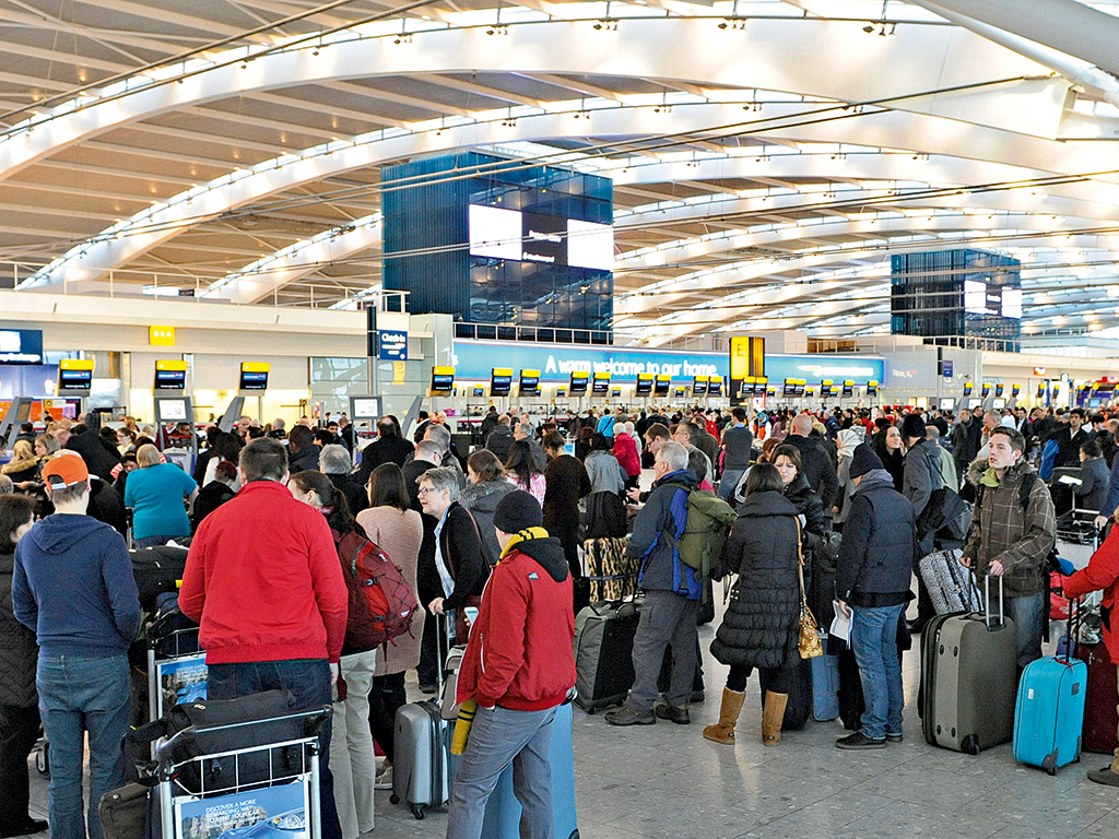Passengers queue at the busy check-in desks at Heathrow