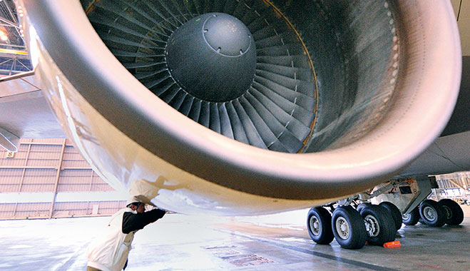 An engineer working on a jet engine