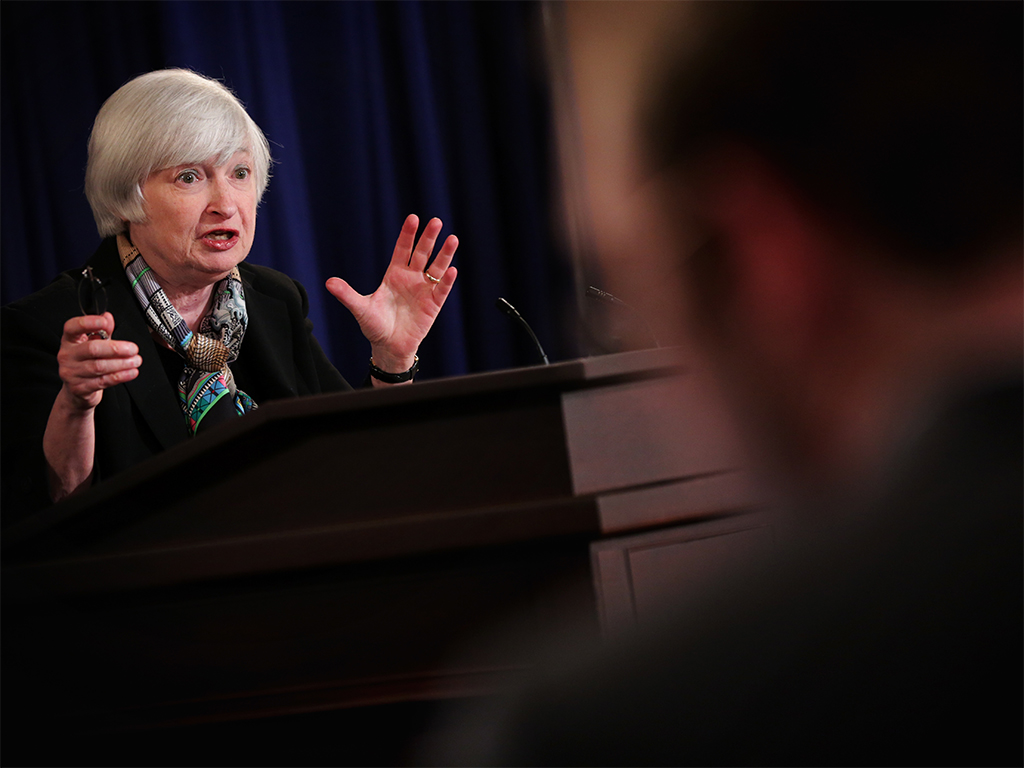 Janet Yellen speaks at a news conference yesterday in which she indicated that the Fed is to rise interest rates sooner than expected