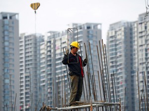 Workers on construction sites in Beijing. China’s construction industry boomed for many years, but appears to have stalled