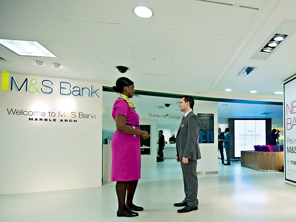 Staff wait in the lobby at the first Marks and Spencer Bank branch on its opening day in Marble Arch, London