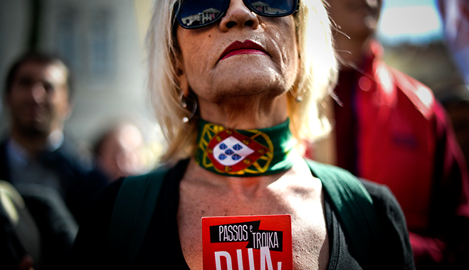 A woman protests against salary cuts and public sector reforms stipulated in the Portuguese government's 2014 budget. There are still challenges ahead for the country's economy - particularly in regards to its unemployment rate - but a financial adjustment programme has helped it in other areas