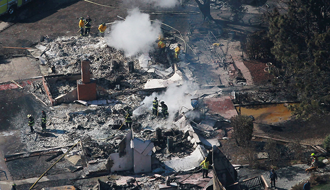 Scenes from the wreckage: Pacific Gas and Electric has been heavily penalised after one of their gas mains exploded in California in 2010, killing eight people and injuring dozens of others