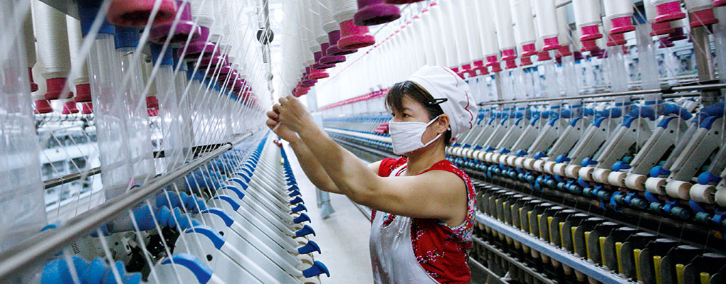 A woman works in a thread factory. Green supply chains are become more and more crucial to businesses