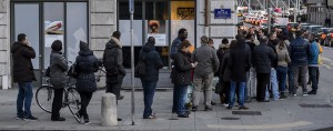 People queue outside a currency exchange office in Geneva, waiting to change their Swiss francs. The Swiss government's decision to peg its currency to the euro has severely damaged the forex industry