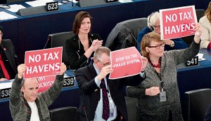 European Parliament members hold placards during a voting session on a censure motion on the European Commission