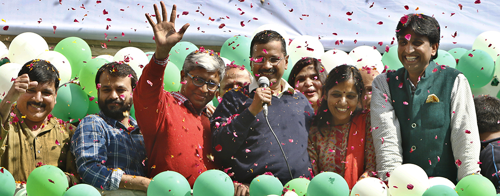 Arvind Kejriwal, leader of the Common Man Party, celebrates after winning in the elections for Delhi's assembly. The party has won popularity due to its pledge to fight for the common man