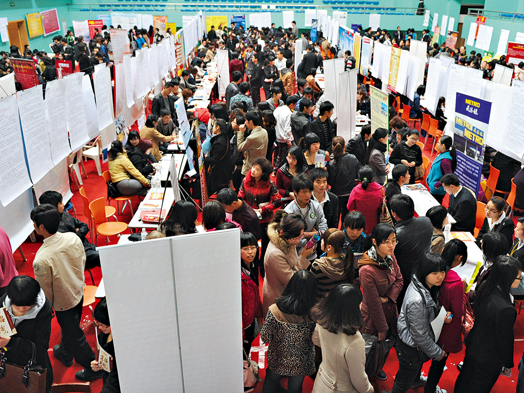 Job seekers attend a job fair in the Fujian Province of China. When the country has raised its minimum wage, the IMF has found evidence employment decreases