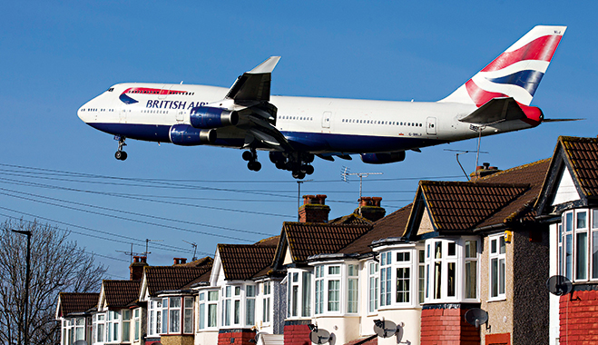 A British Airways 747 flies over rooftops as it comes in to land at Heathrow