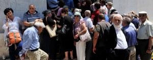 Rush for cash: pensioners queue outside a closed branch of the Green National bank as the government ordered a shutdown of banks in the country