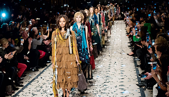 Burberry models on the catwalk. The brand managed to alter its image, from football hooligan to high-end fashion