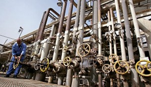 A worker adjusts control valves at the Daura oil refinery in Baghdad, Iraq
