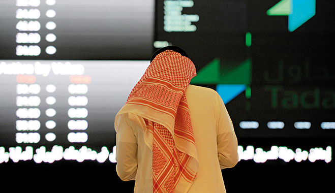 A Saudi investor monitors the stock exchange at the Tadawul, Saudi Arabia’s stock exchange