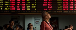 People watch monitoring screens at a brokerage house in Shanghai. The Chinese government is trying to bring the country's economy more stability with a new "circuit breaker" system