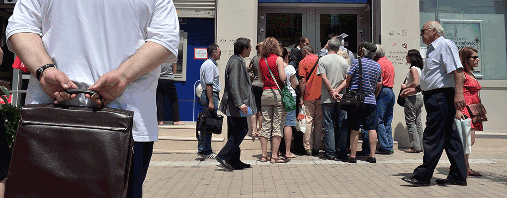 People queue outside a bank in Athens, Greece. A new loan from international lenders could spur on the country's economy