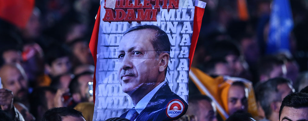 People hold a flag of Turkish President Tayyip Erdogan. Some fear his re-election marks the end of a democratic Turkey and the beginning of a dictatorship