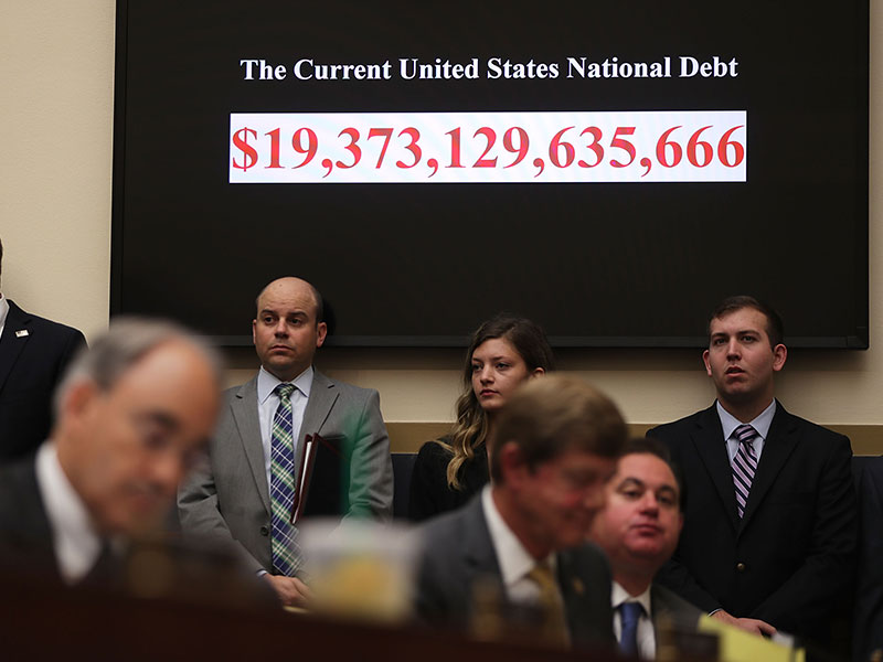 A clock showing the current national debt of the US is seen during a hearing before the House Financial Services Committee. The IMF has warned governments over increasing global debt levels