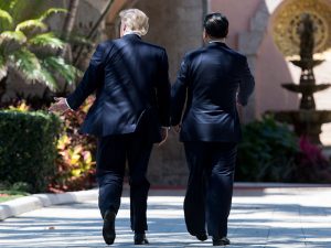 Donald Trump and Xi Jinping walk together at Trump's Mar-a-Lago estate in Florida. The two presidents have agreed to instigate a 100-day plan aimed at addressing the trade deficit between the two countries