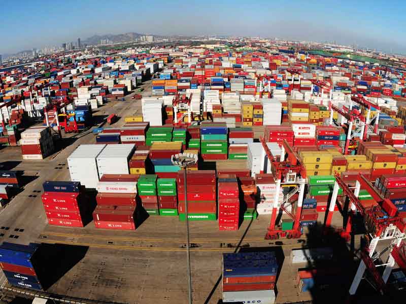 Containers are offloaded at Qingdao Port in China. There are concerns that the country would benefit from artificially cheap exports were it to gain market economy status