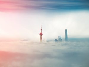 Commercial buildings immersed in fog in Shanghai, China. Despite being the world's largest emitter of greenhouse gas, China is now leading the charge for green energy development