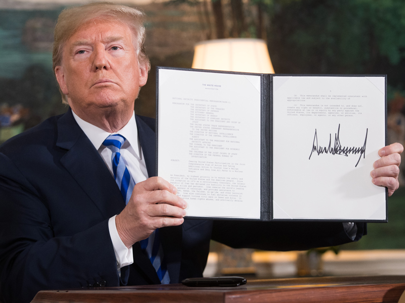 US President Donald Trump displays the document that reinstates sanctions against Iran after announcing the US withdrawal from the Iran nuclear deal