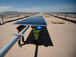 Workers install solar panels at the Villanueva solar photovoltaic power plant near Villanueva, Mexico. The country's renewable energy policy has become highly advanced in recent years